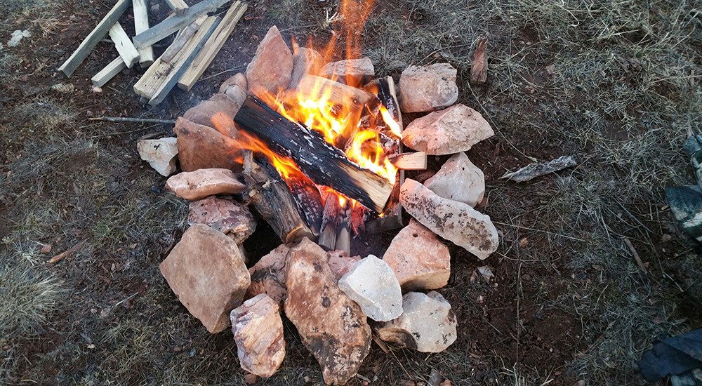 Campfire surrounded by rock border.