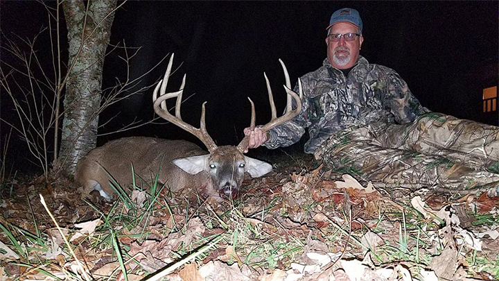 Hunter with large whitetail buck in Kentucky