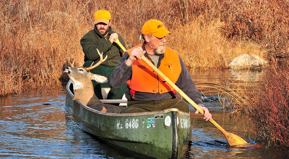 Hunters in Canoe with Deer