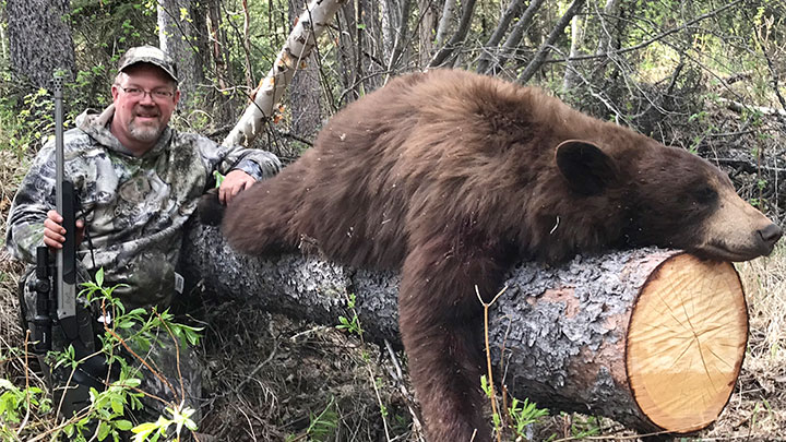 Alberta hunter with color-phase black bear