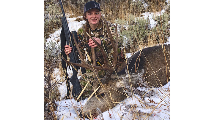 Female hunter with mule deer in Montana