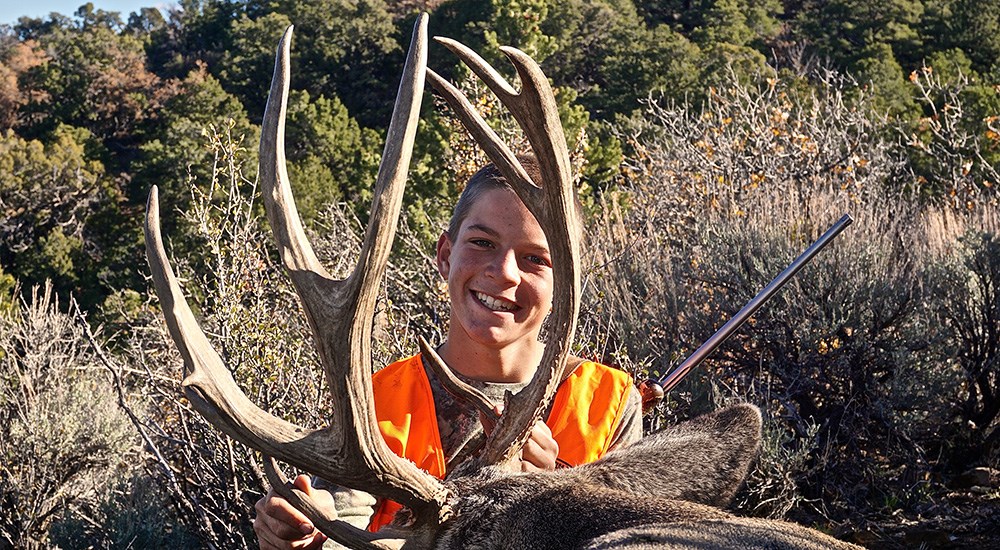 Young Hunter with Mule Deer