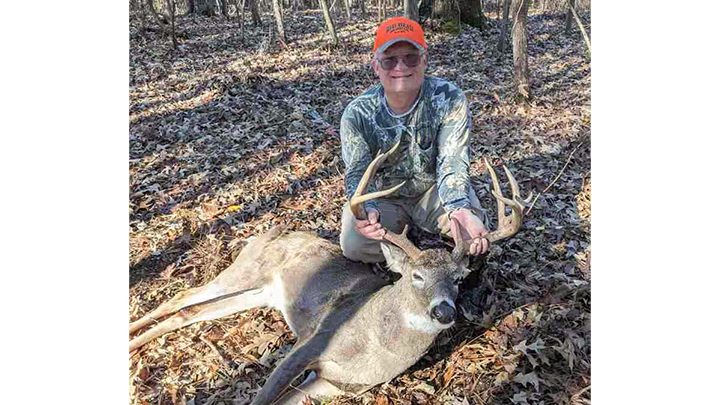 Hunter with whitetail buck taken in Wyoming