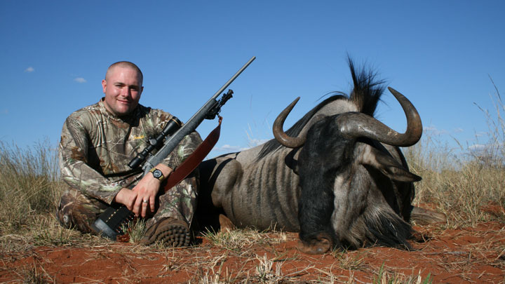 Hunter poses with a Nosler TGR next to a downed Wildebeest