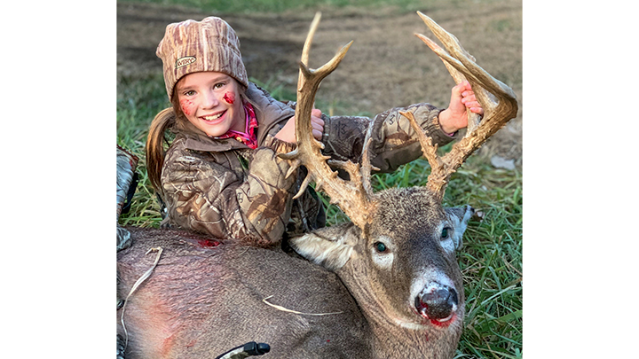 10-year-old girl with her first buck taken with a crossbow