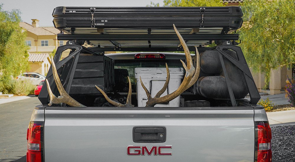 Rearview of truck bed with rack storage system and elk antlers.