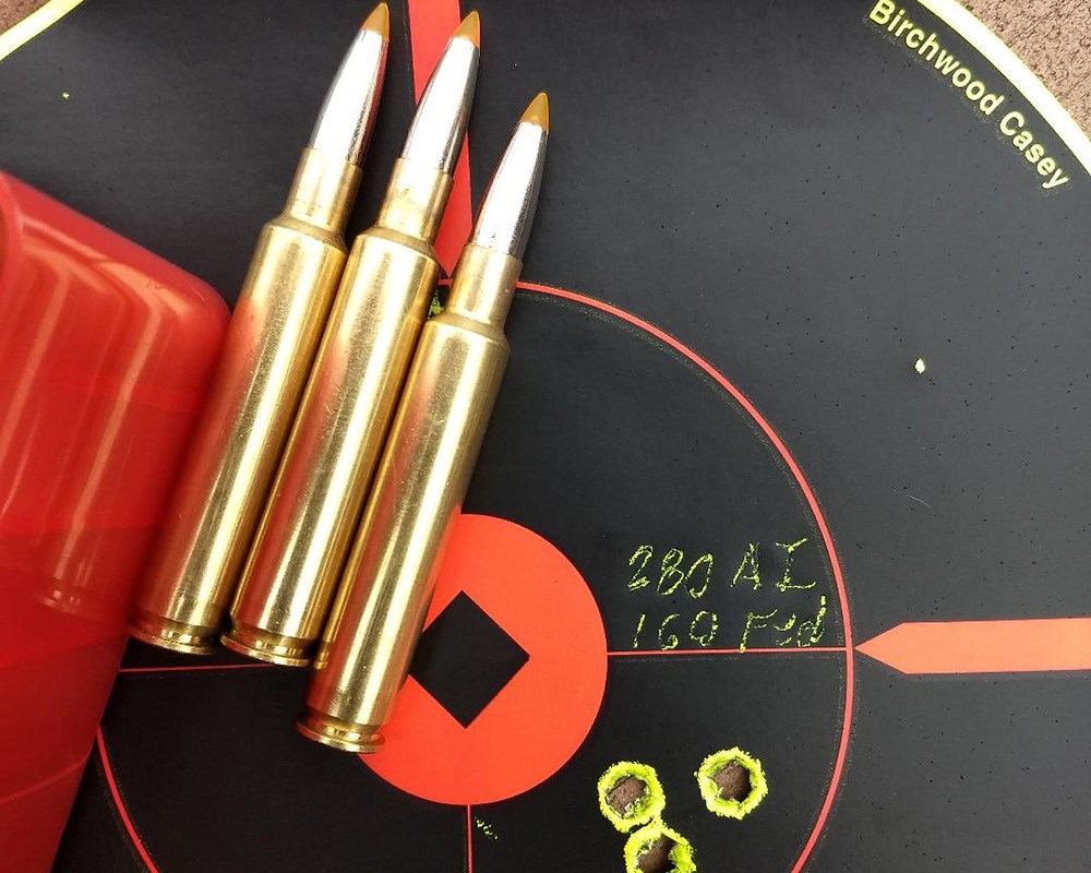 .280 Ackely Improved rifle cartridges laying on black shooting target.