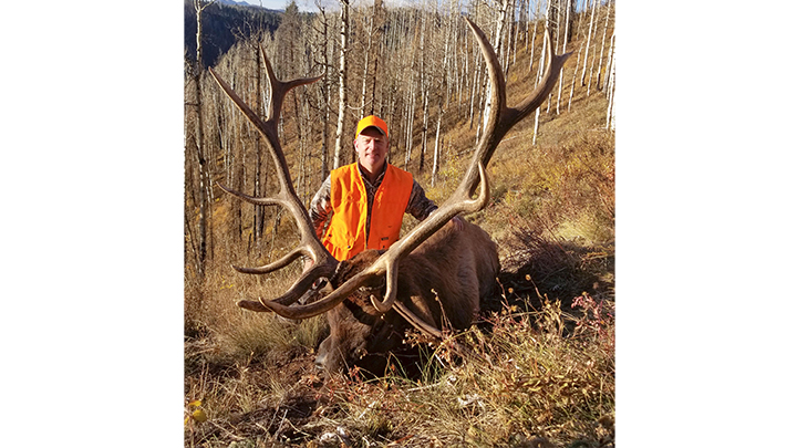 Hunter with large 6-by-6 bull elk in Colorado