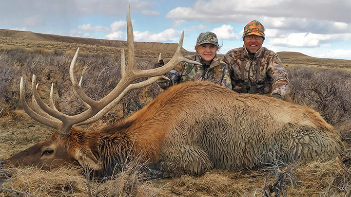 Female hunter with Wyoming bull elk