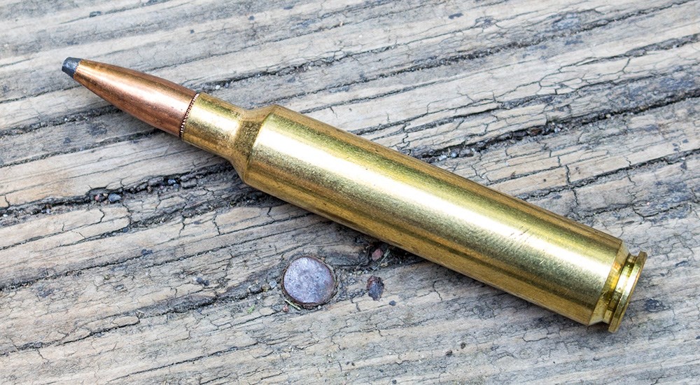 6.5 Weatherby Rebated Precision Magnum cartridge on wood.