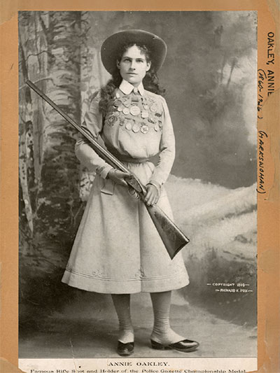 Annie Oakley holding shotgun