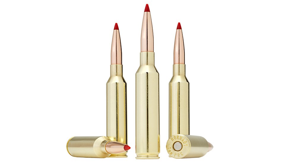 Five Hornady 7mm PRC ammunition cartridges on white background.