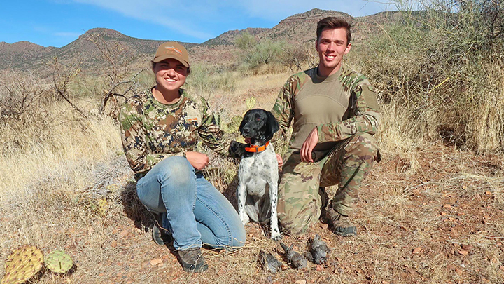 Male and female desert quail hunters with hunting dog