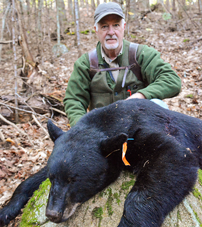 Hunter with black bear