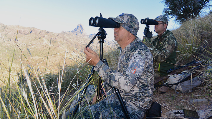 Hunters looking through binoculars