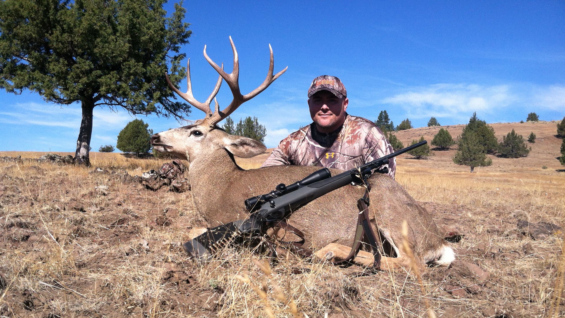 Author pictured with Mule Deer and Rifle