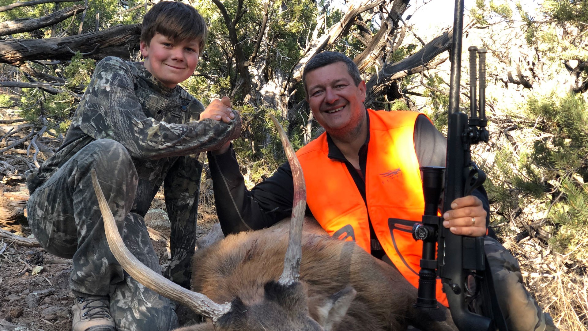 Youth hunter with mentor and spike elk