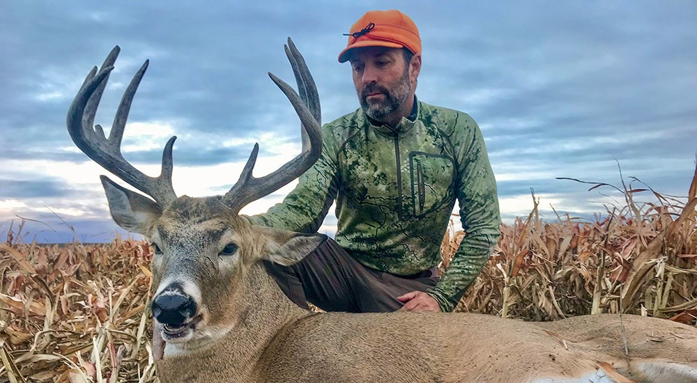 Hunter with whitetail buck in South Dakota