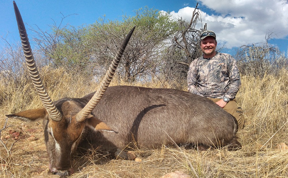 Hunter with waterbuck in Namibia