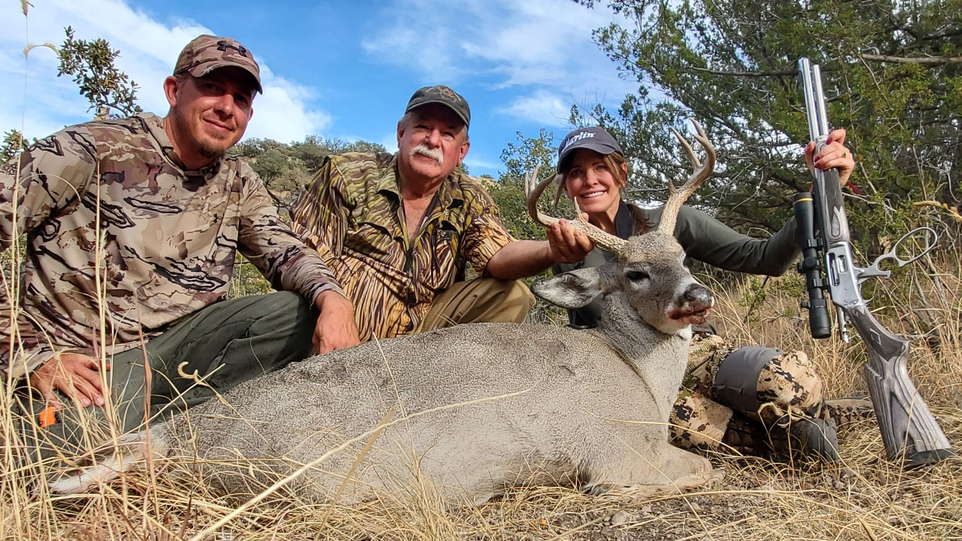 Mehall and guides posing behind buck with Marlin 1895 SBL