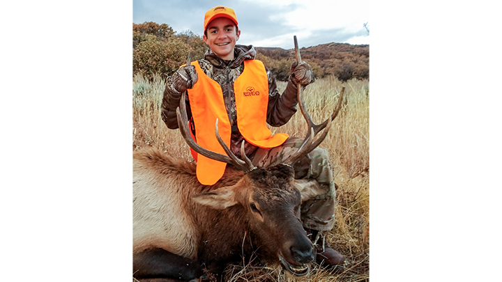 Young hunter with first bull elk taken in Colorado