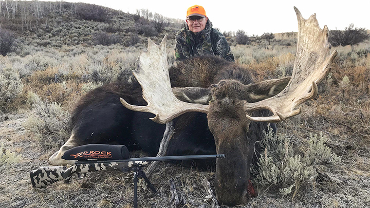 Elderly hunter with bull moose taken in Wyoming