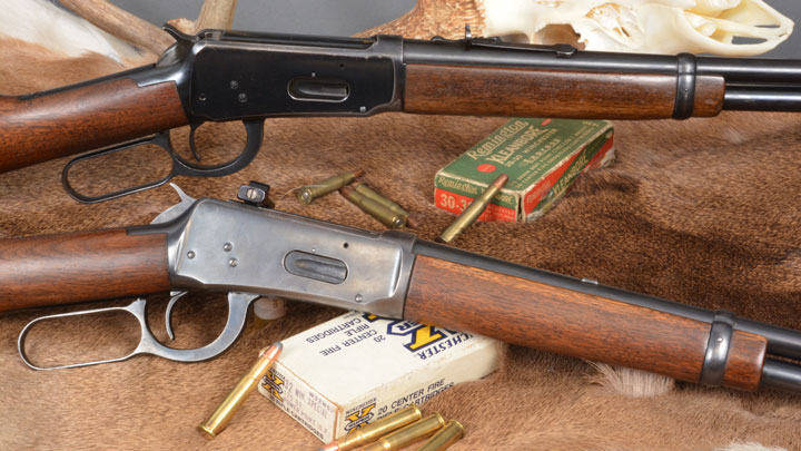 Winchester Model 94 with .32 Win. Spl. cartridges beneath it.