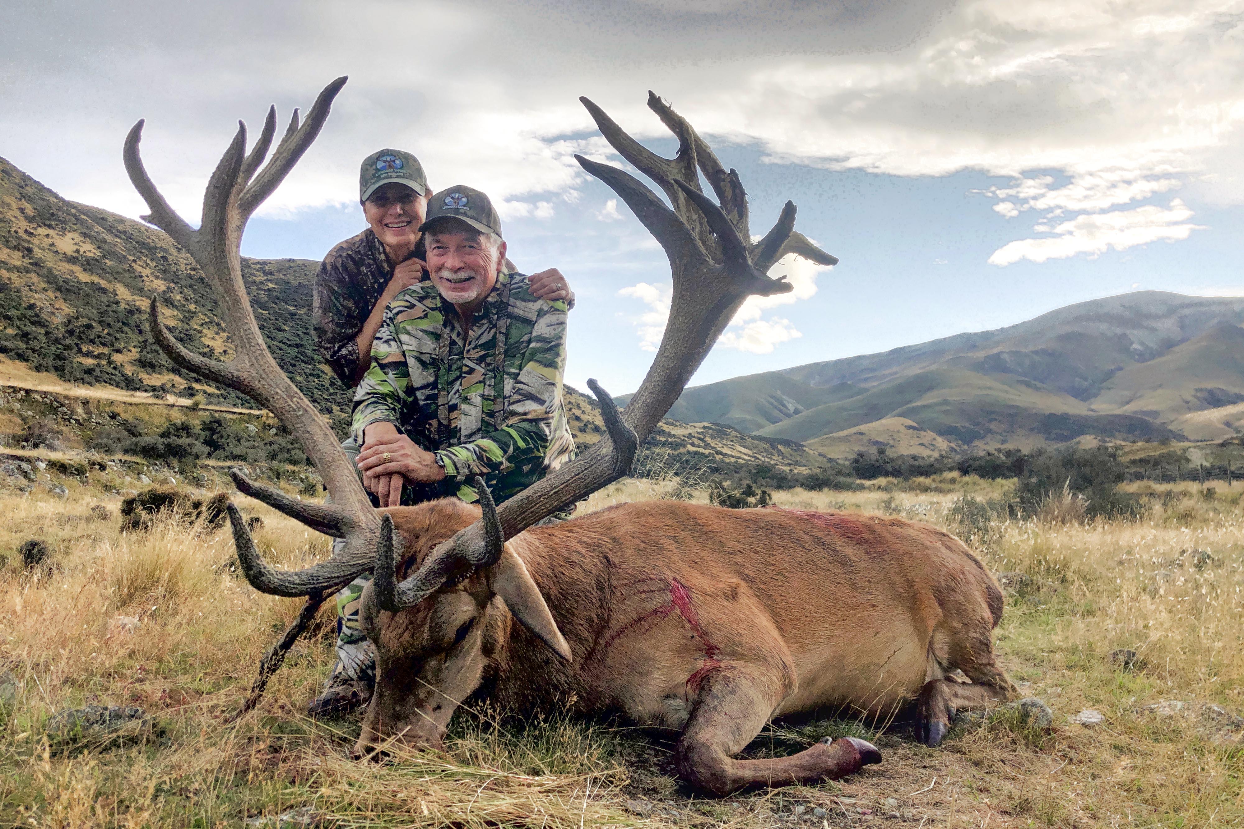 Hunter and wife with red stag bull in New Zealand