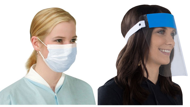 Woman in light blue scrubs wearing a cloth facemask, and woman in dark scrubs utilizing a face shield