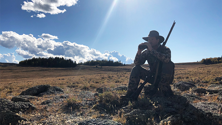 Hunter glassing Western mountains for game