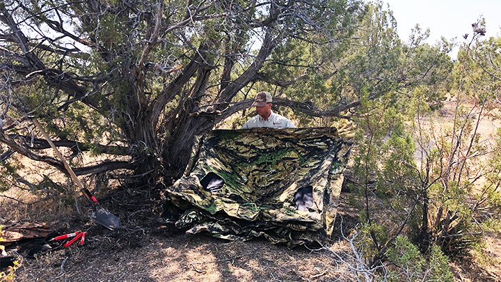 Hunter setting up Primos Double Bull ground blind