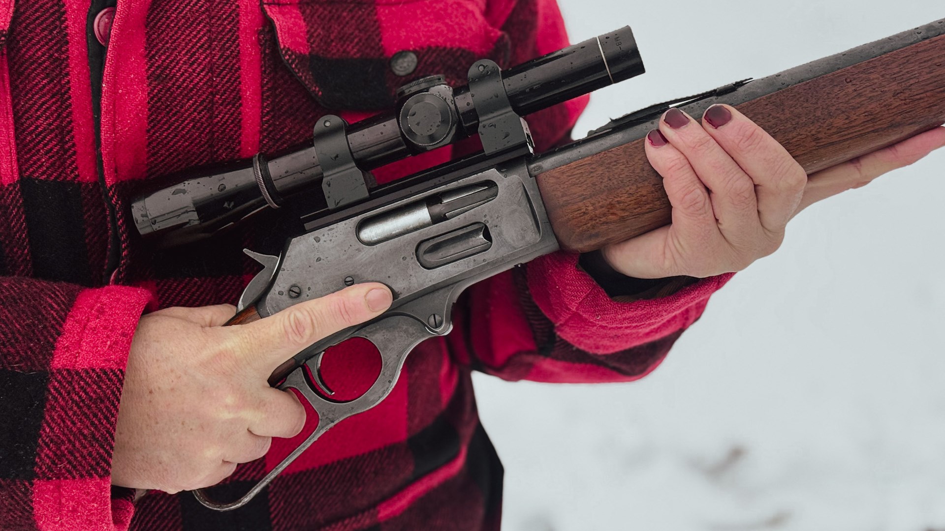 Lever gun with red plaid