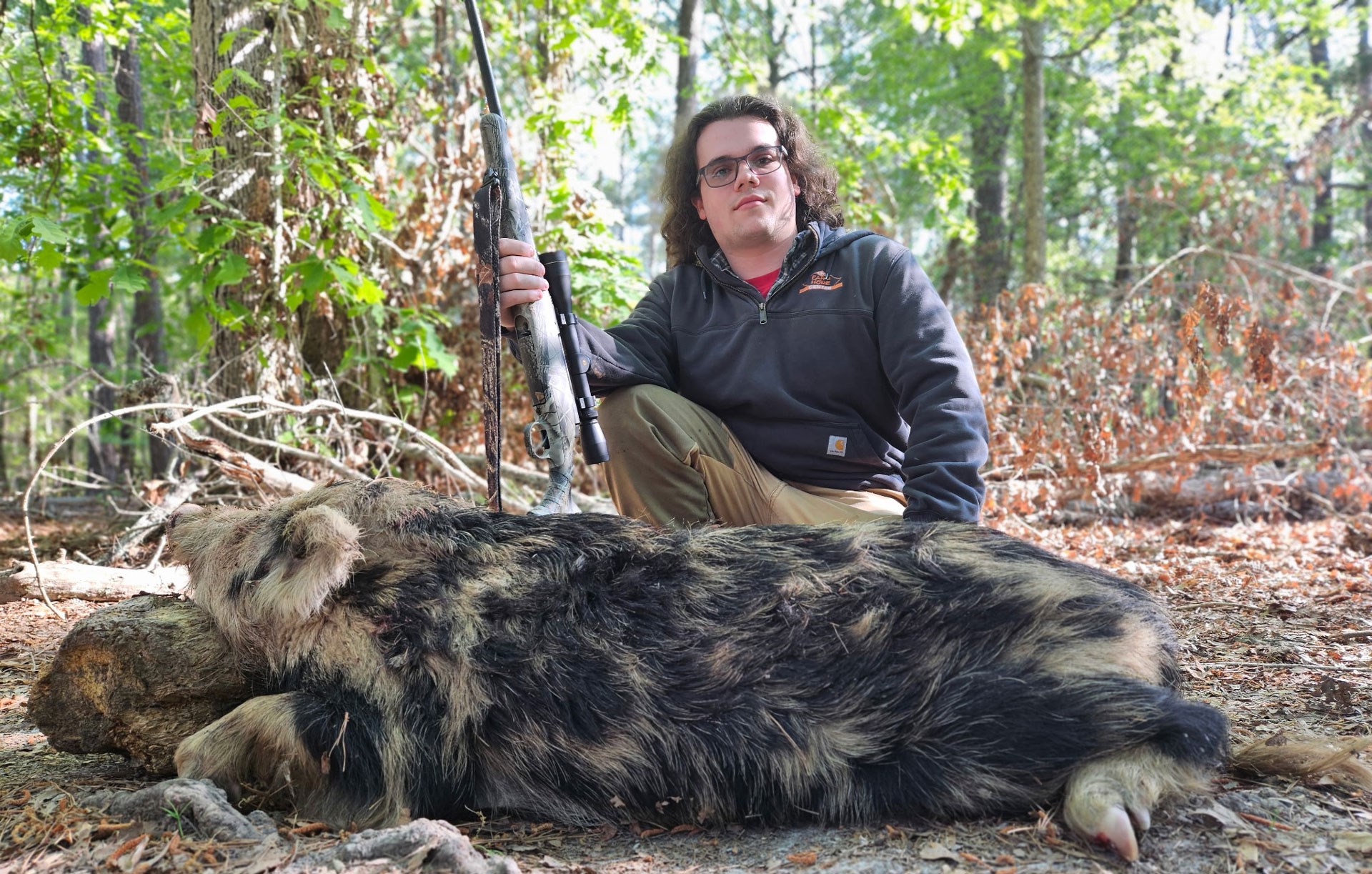 Young hunter with hog