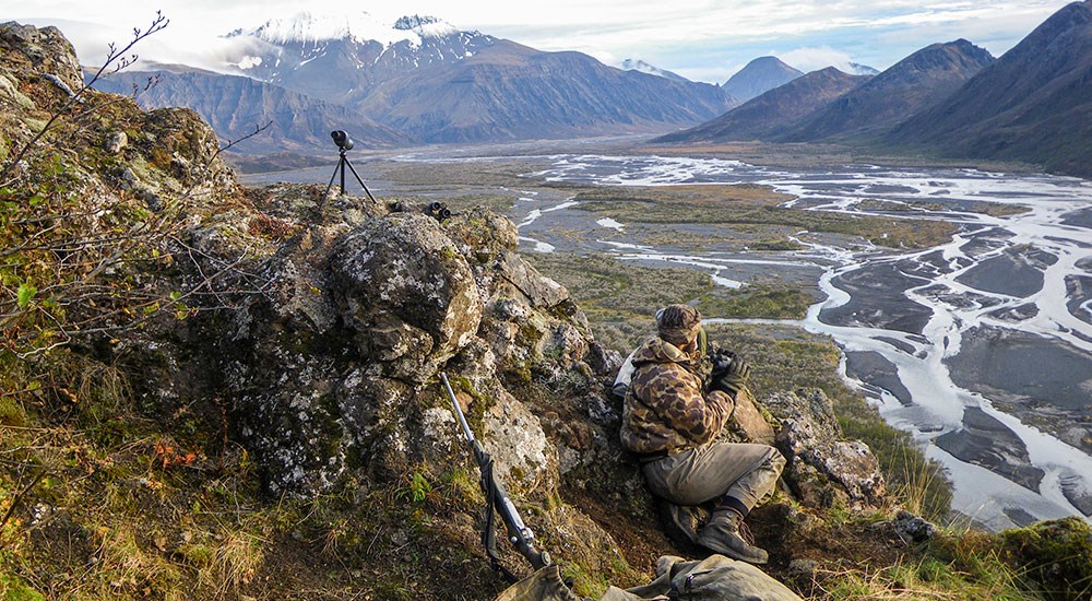 Hunter searching from game on Alaska mountainside