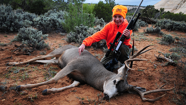 Youth Female Hunter with Mule Deer Buck Taken with Rifle Chambered in 6.5 Creedmoor