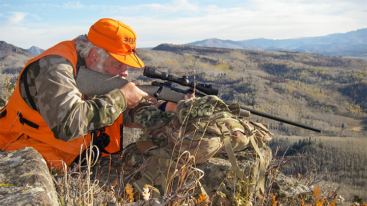 Hunter in Western Mountains Shouldering Rifle