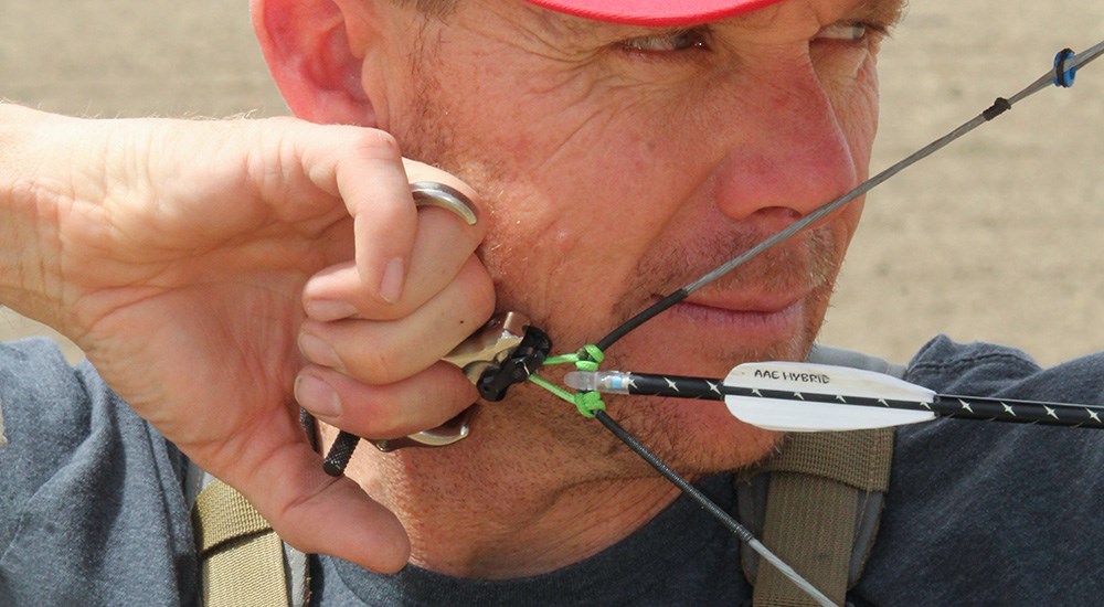 Man Pulling Back Compound Bow