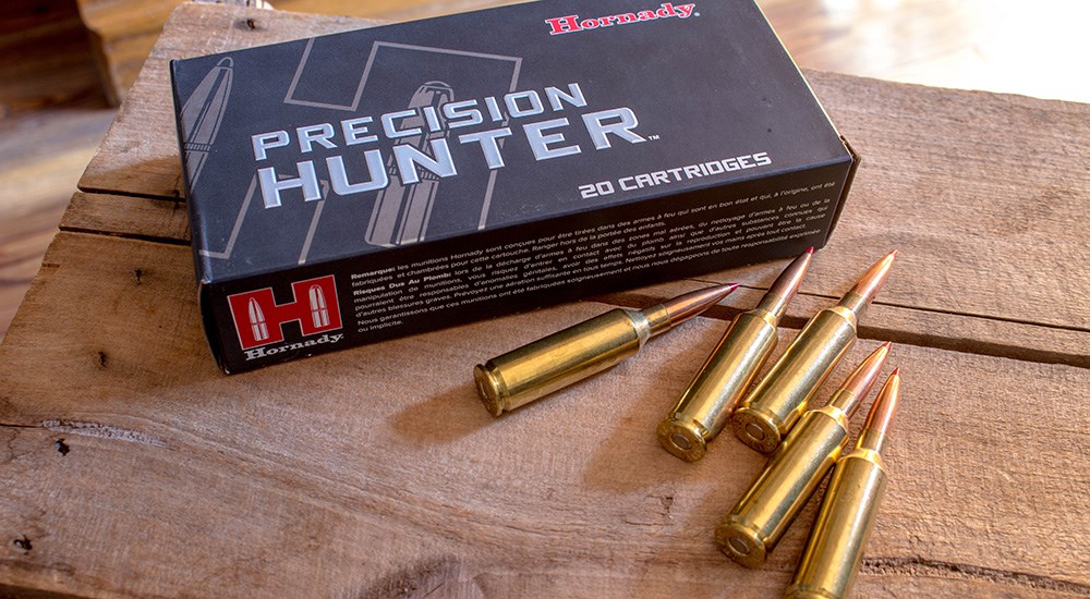Hornady 6.5 Precision Rifle Cartridge ammunition laying on wood table.