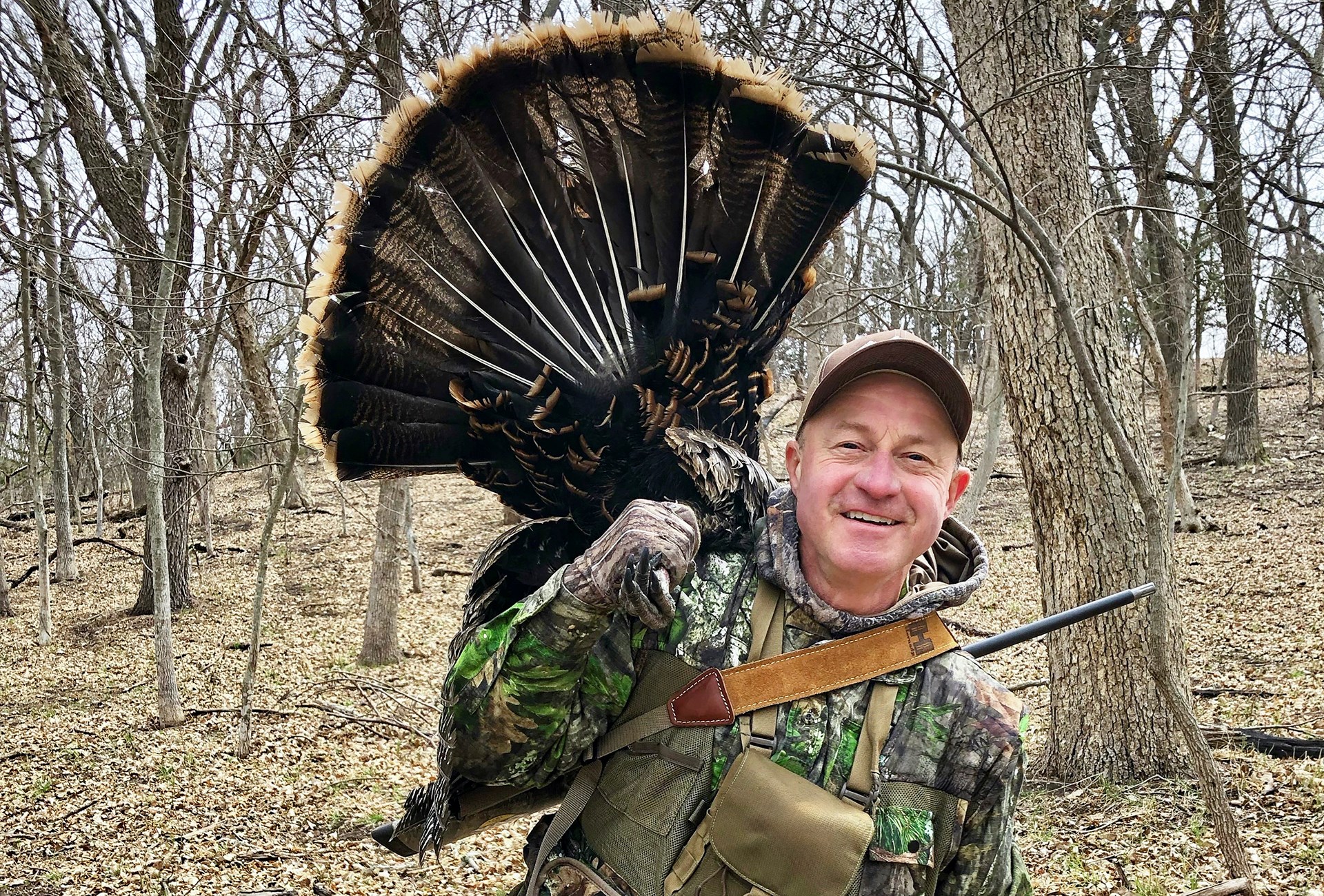 Hunter with Turkey over shoulder
