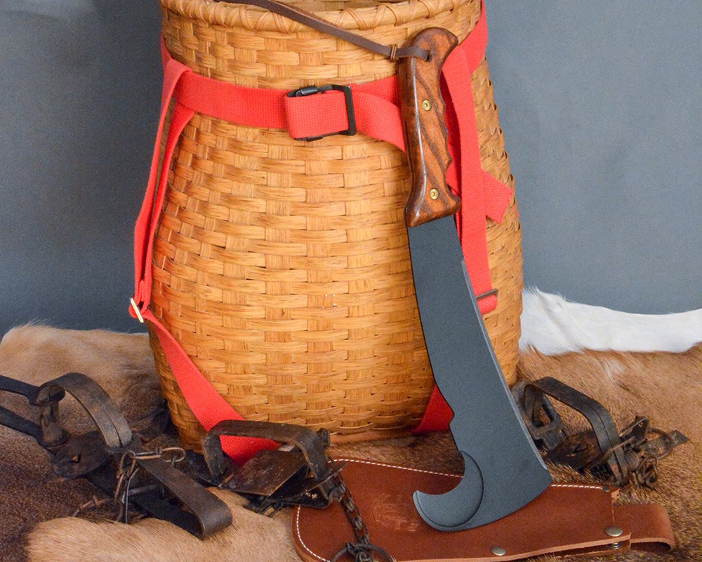 Woodsman's Pal Brush Axe Leaning Against Wicker Basket