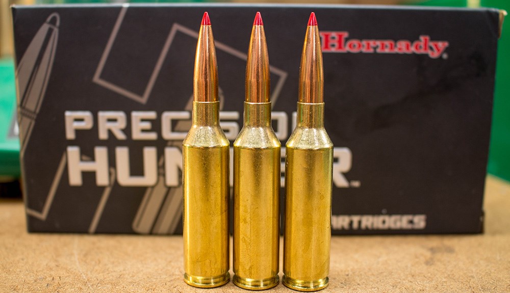 Hornady Precision Hunter 6.5 PRC ammunition cartridges standing in front of ammunition box.