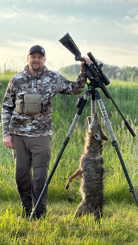 Dead coyote hanging from tripod
