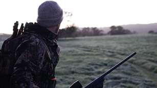 mainman-wearing-gray-and-black-camouflage-jacket-holding-rifle-2954926.jpg