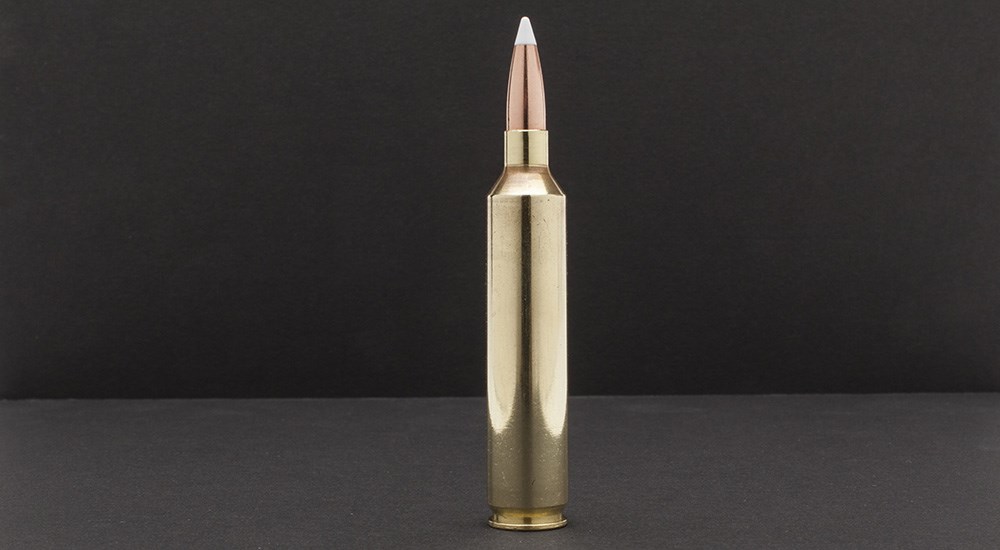 Single 26 Nosler ammunition cartridge on black background.