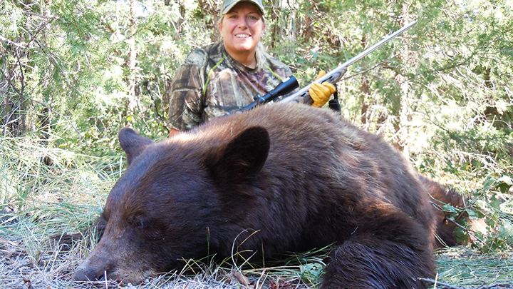 Hunter with Color-Phase Black Bear Taken in New Mexico