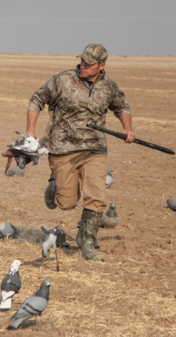 Hunter running with a retrieved bird