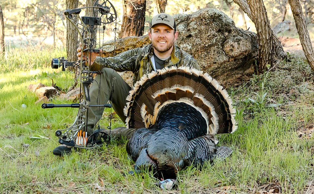 Bow Hunter with Merriam's Turkey