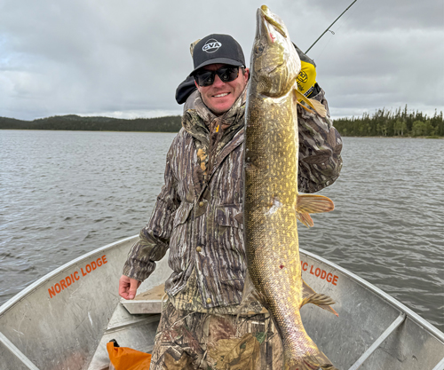 Though many hunters may balk at sitting in a blind in solitude, the author enjoys the silence and the anticipation of waiting for a bear to suddenly appear. Smoke prevented hunting most days. Good thing fishing luck included a boatload of pike.