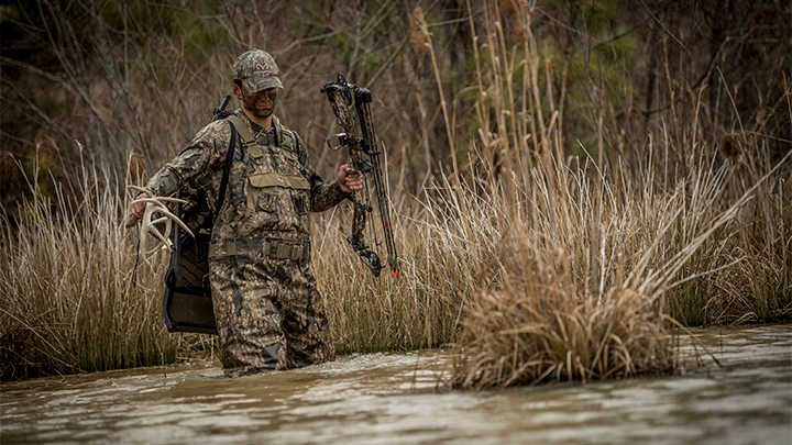 Deer Hunter Crossing Stream