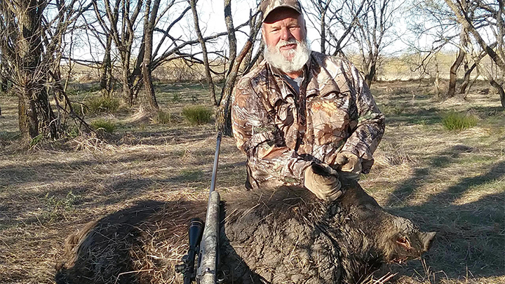 Hunter with feral hog in Texas